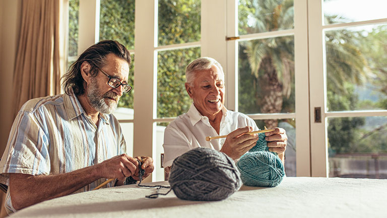 Machine Learning and Its Human Inspiration 1 DeeLab, Machine Learning, Old men sitting at home and knitting sweater with the knitting needles and woolen threads. Senior people learning knitting at retired age.