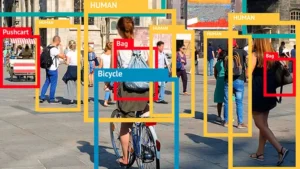 People and objects in a busy city center labeled with bounding boxes, illustrating the process of image labeling that identifies different aspects within a complex scene.