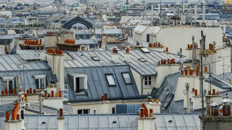 Aerial view of Parisian rooftops, showcasing a variety of roof styles and conditions, highlighting the importance of regular inspections and roof annotation in maintaining structural soundness. DeeLab.ai, Data Annotation.