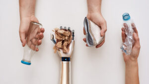 A row of hands holding different types of waste, such as plastic, paper, and metal; one hand is robotic, symbolizing the role of AI, data annotation and automation in modern waste segregation.