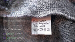 DeeLab, Data Annotation services. Close-up of fabric with a clothing tag reading “73% Cotton, 22% Polyester, 5% Lycra,” overlaid on the left with machine learning code, symbolizing the mix of natural and synthetic elements in both textiles and data.
